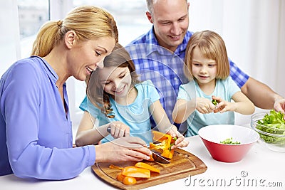 Happy family with two kids cooking at home Stock Photo