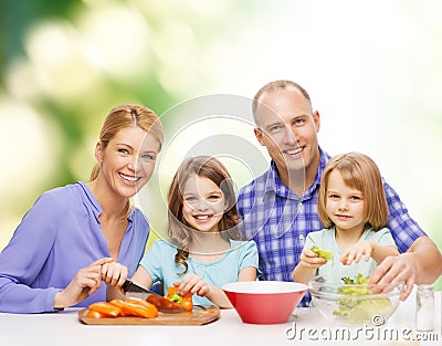 Happy family with two kids making dinner at home Stock Photo