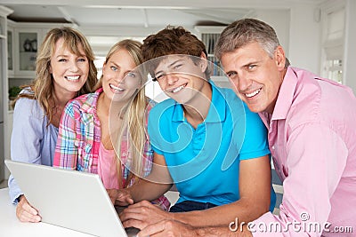 Happy family using laptop together Stock Photo