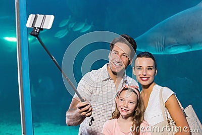 Happy family using selfie stick Stock Photo