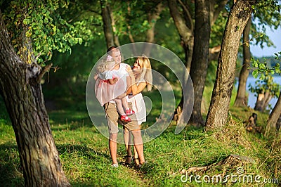 Happy family walks in a lakeside park Stock Photo