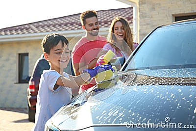 Happy family washing car at backyard Stock Photo