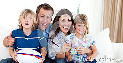 Happy family watching a rugby match Stock Photo