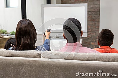 Happy family watching tv on the sofa Stock Photo