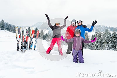 Happy family in winter clothing at ski resort - skiing, winter, snow, fun - mom and daughters enjoying winter vacations Stock Photo