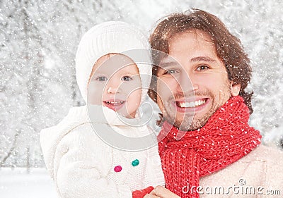 Happy family on a winter walk, father and child baby daughter outdoors Stock Photo
