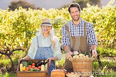 Happy farmer couple presenting their local food Stock Photo