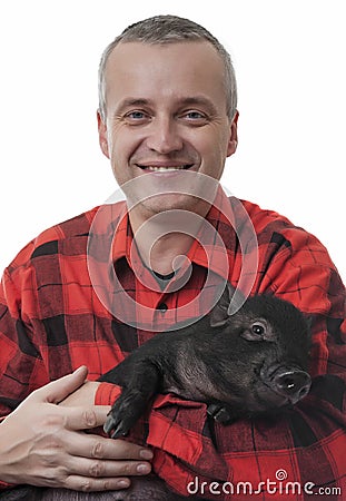 A happy farmer with a little piglet Stock Photo