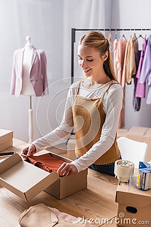 happy fashion boutique owner packing cardboard Stock Photo