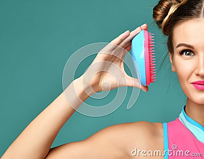 Happy fashion brunette woman close eye with colorful pink blue popular hair comb brush Stock Photo