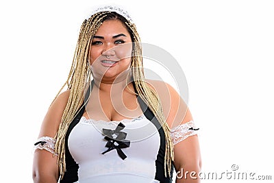 Happy fat Asian cleaning lady smiling while wearing maid co Stock Photo