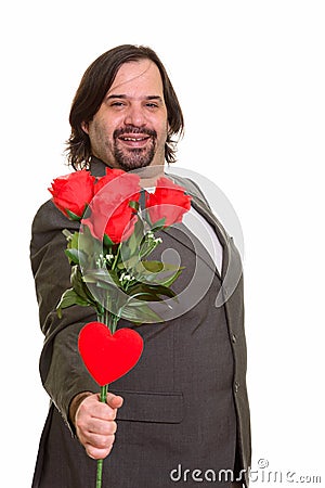 Happy fat Caucasian businessman smiling giving red roses and hea Stock Photo