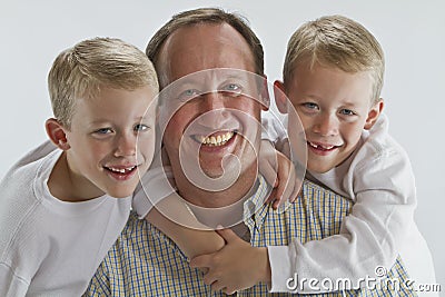 Happy father with 6 years old identical twins Stock Photo