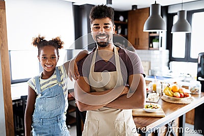 Happy father and children in the kitchen. Healthy food, family, cooking concept Stock Photo
