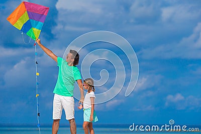 Happy father and cute little daughter flying kite Stock Photo