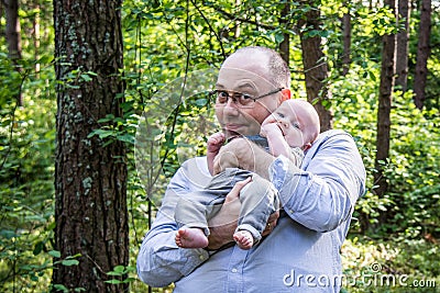 Happy father holds his treasure son Stock Photo