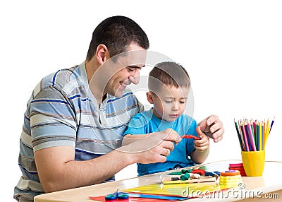 Happy father and kid boy play clay together Stock Photo