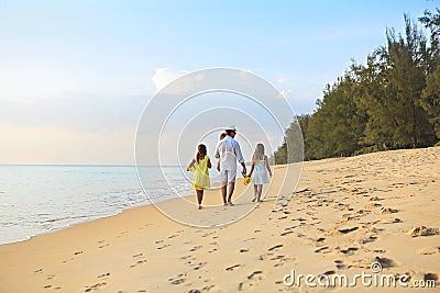 Happy father with kids have fun on beach walking at sunset Stock Photo