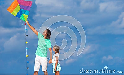 Happy father and little girl flying kite together Stock Photo