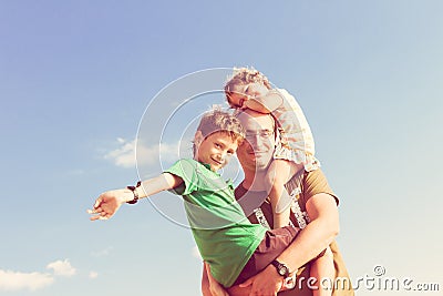 Happy father playing with kids outdoors Stock Photo