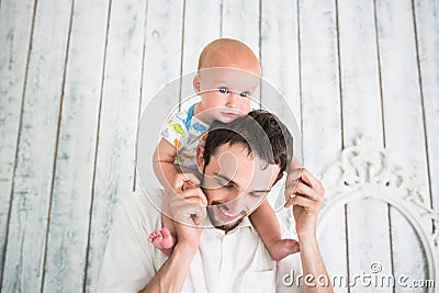 Happy father plays with little mischievous son Stock Photo