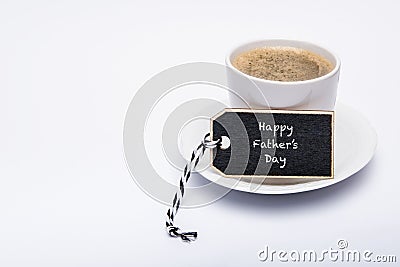 Happy Father`s Day Background. Cup of coffee on white background with gift tag. Stock Photo