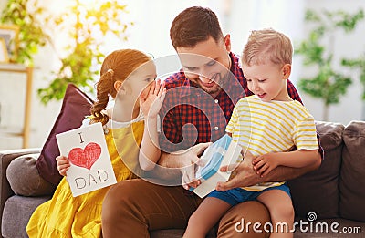 Happy father`s day! Children congratulates dad and gives him gift and postcard Stock Photo