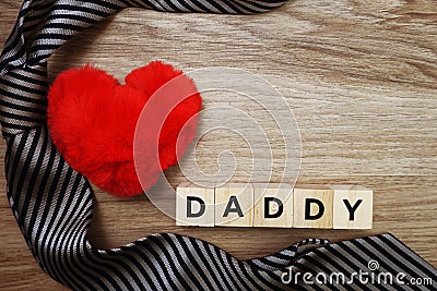 Happy Father`s Day concept with DADDY alphabet letter with space copy on wooden background Stock Photo