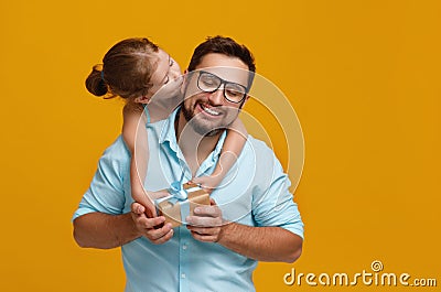 Happy father`s day! cute dad and daughter hugging on yellow back Stock Photo