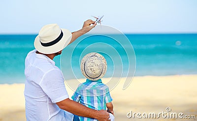 Happy father`s day! dad and child son on beach by sea with model toy plane Stock Photo