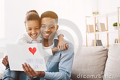 Happy father`s day. Daughter congratulating dad at home Stock Photo
