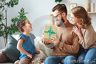 Happy father`s day! family mom and daughter congratulate dad and give gift Stock Photo