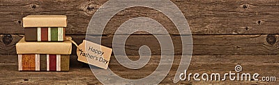 Happy Fathers Day gift tag and two stacked boxes against a wood banner background Stock Photo