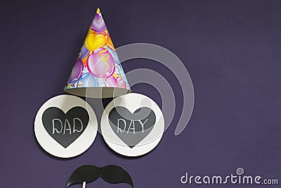 Happy father`s day. On a purple background - black mustache, festive cap, two hearts with the inscription daddy`s day Stock Photo