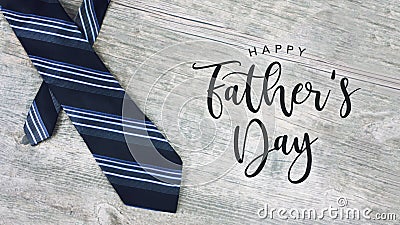 Happy Father`s Day Text with Striped Tie Over Wood Background Stock Photo