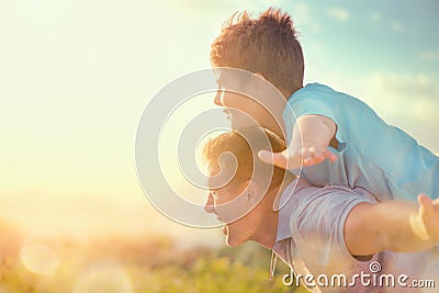 Happy father and son having fun over beautiful sky outdoors Stock Photo