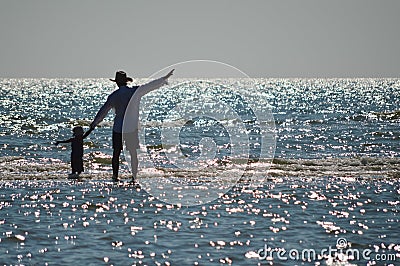 Happy father and son on seashore beach having fun Stock Photo