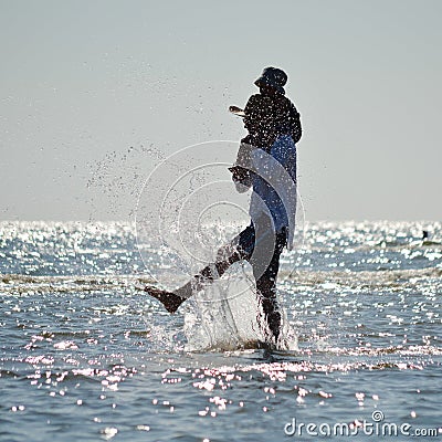 Happy father and son on seashore beach having fun water splash Stock Photo