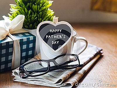 Happy fathers day concept. coffee cup with gift box, heart tag w Stock Photo