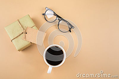 Happy Fathers Day concept. Gift present box, eyeglasses, mustache, cup of coffee on background Stock Photo