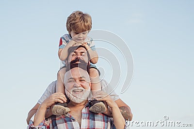 Happy fathers day. Father and son enjoying outdoor. Men generation: grandfather father and grandson are hugging looking Stock Photo