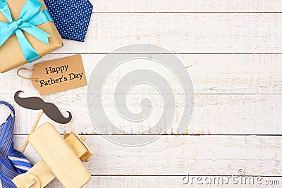 Happy Fathers Day gift tag with side border of gifts, ties and decor on white wood Stock Photo