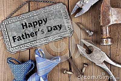 Happy Fathers Day metal sign with tools and ties on wood Stock Photo