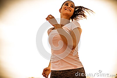 Happy and feel good running at sunny day. Young woman. Stock Photo