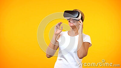 Happy female gamer wearing virtual reality headset, modern technology cyberspace Stock Photo
