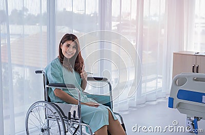 Happy female patient in hospital room Stock Photo