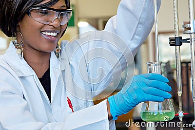 Happy female researcher in chemical lab Stock Photo