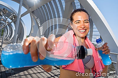 Happy female runner with energetic drinks for hydration Stock Photo