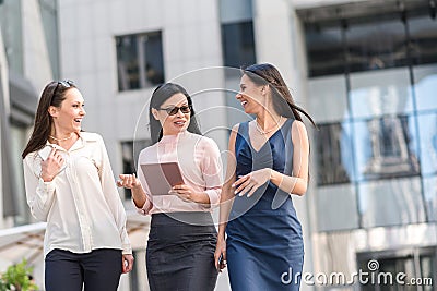 Happy females talking on street Stock Photo