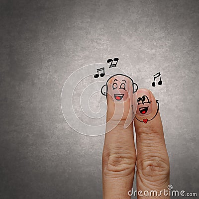 Happy finger couple in love with painted smiley and sing a song Stock Photo